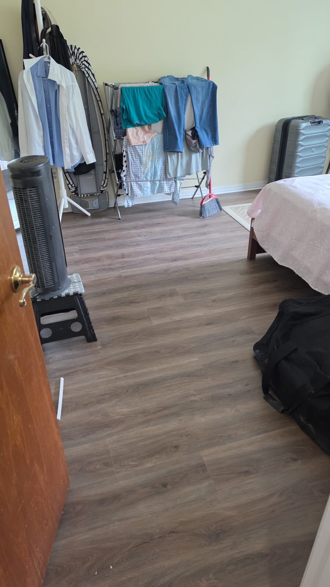 Bedroom with new vinyl plank flooring and the tenant's furniture set back in place