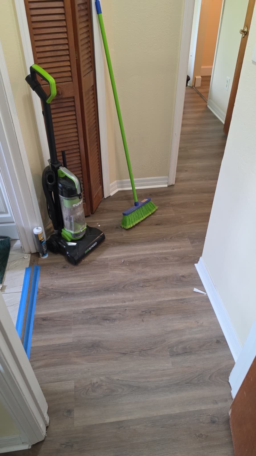 Hallway with new vinyl plank flooring and fresh baseboards