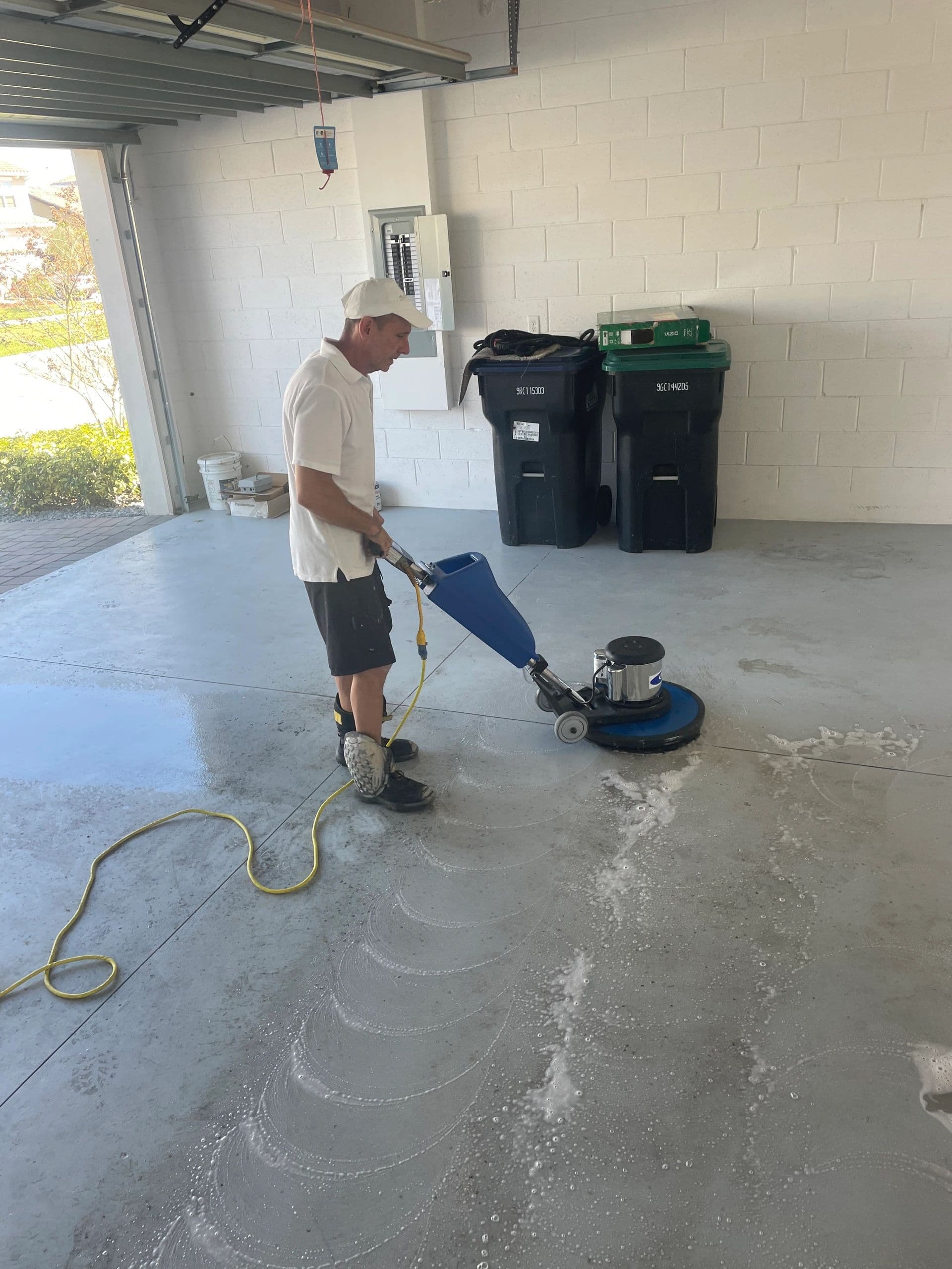 Best Cleaning & Restoration team member buffing a garage floor