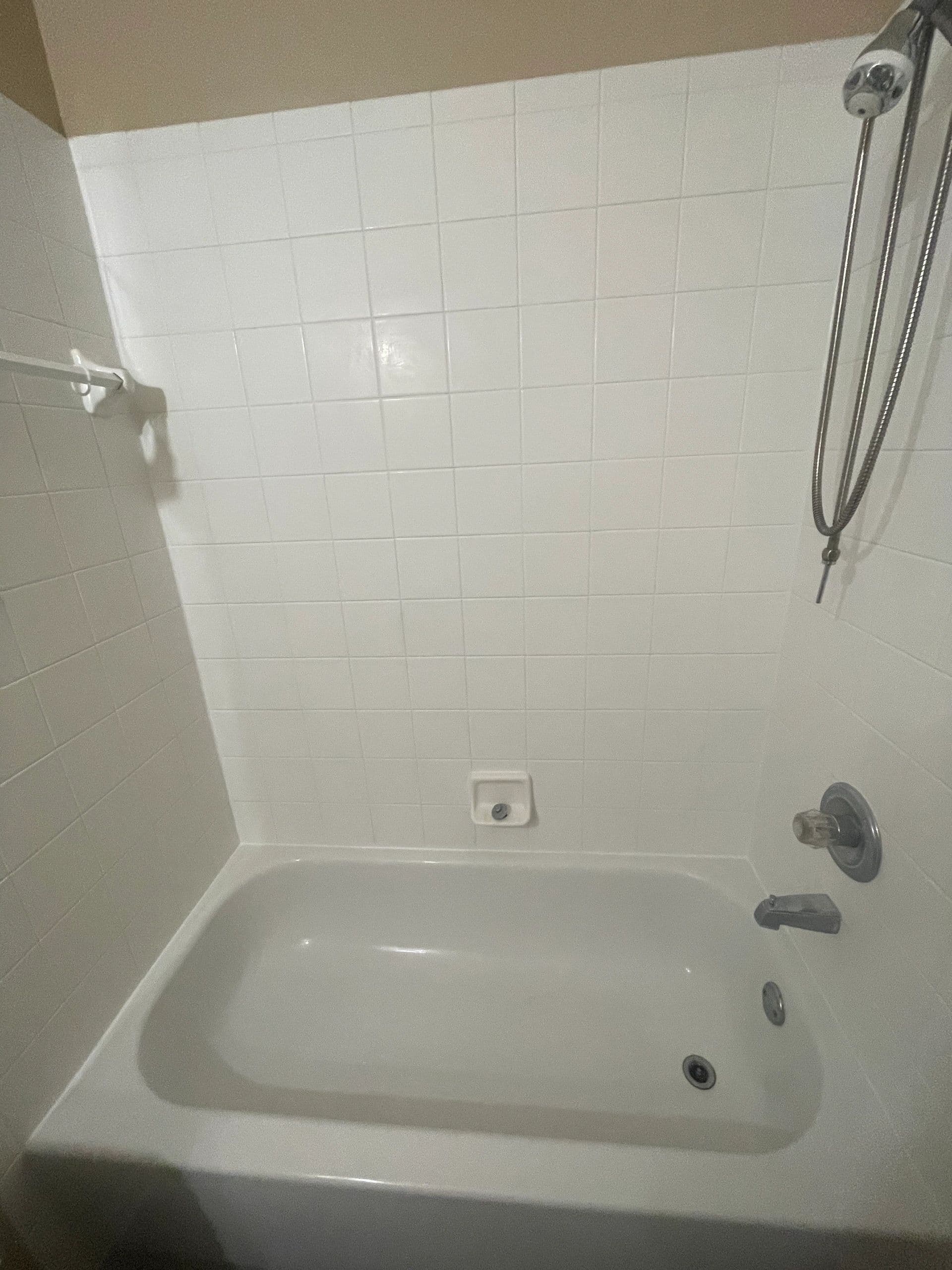 Restored white tile shower and tub surround by Best Cleaning & Restoration in Central Florida